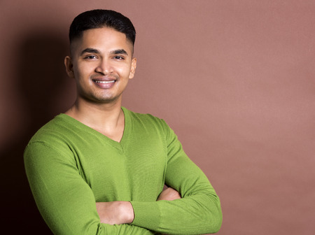 young casual man wearing green on brown backgroundの写真素材