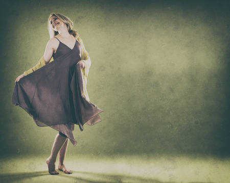 blond woman wearing green scarf on vintage backgroundの写真素材