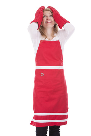 blond woman wearing red apron on white isolated backgroundの写真素材