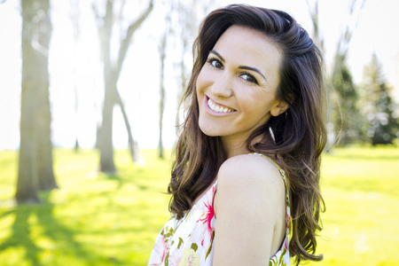 young brunette wearing summer outfit outdoorsの写真素材