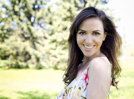 young brunette wearing summer outfit outdoorsの写真素材