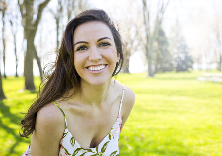 young brunette wearing summer outfit outdoorsの写真素材