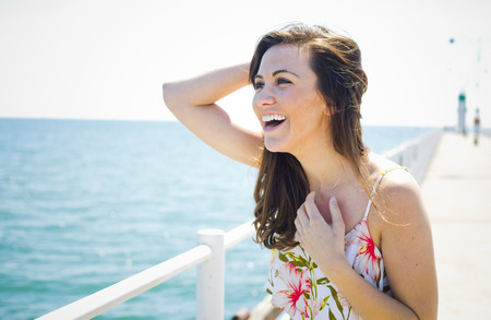 young brunette wearing summer outfit on the beachの写真素材