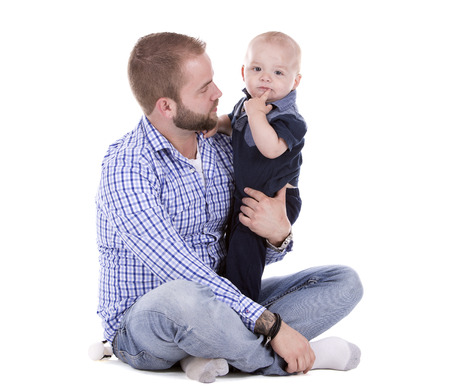 casual father and son sitting on white isolated backgroundの写真素材