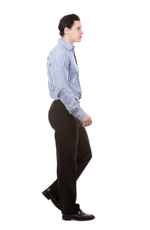 young caucasian man wearing blue shirt and black pants on white backgroundの写真素材