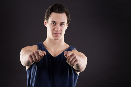 fitness caucasian young man posing on dark backgroundの写真素材