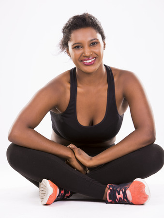 young black woman wearing fitness outfit on white isolated backgroundの写真素材