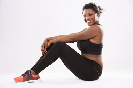 young black woman wearing fitness outfit on white isolated backgroundの写真素材
