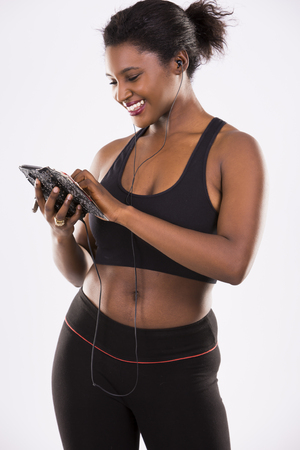 young black woman wearing fitness outfit on white isolated backgroundの写真素材
