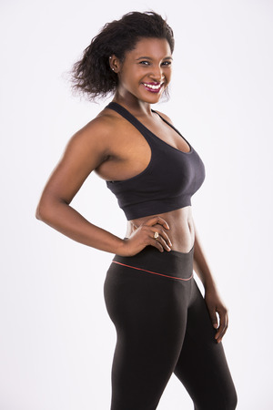young black woman wearing fitness outfit on white isolated backgroundの写真素材