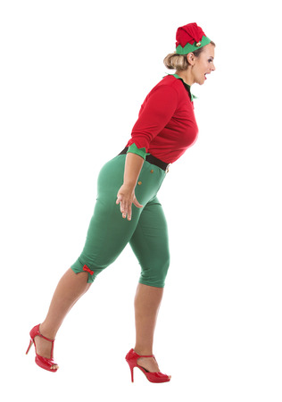 blonde woman wearing elf christmas costume on white backgroundの写真素材