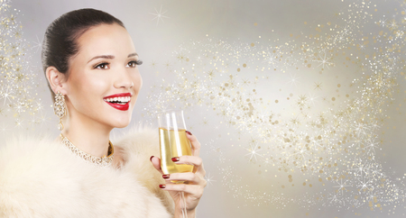 Upscale woman wearing gold jewellery and red lipstick on light backgroundの写真素材