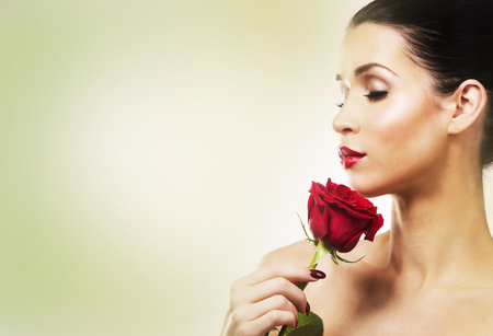 beautiful woman with dramatic makeup and red lips. Red flower rose.の写真素材
