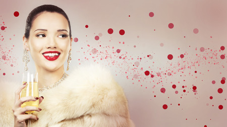 Upscale woman wearing gold jewellery and red lipstick. Red hearts. Light background.の写真素材