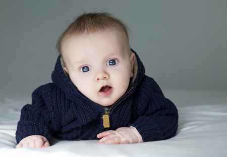 baby boyl is posing wearing blue dark outfitの写真素材