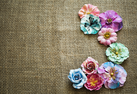 arrangement of colorful flowers laid on sack textureの写真素材