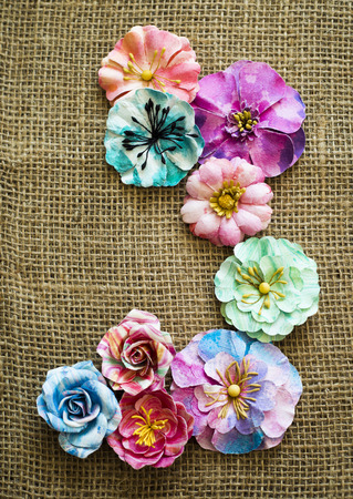 arrangement of colorful flowers laid on sack textureの写真素材