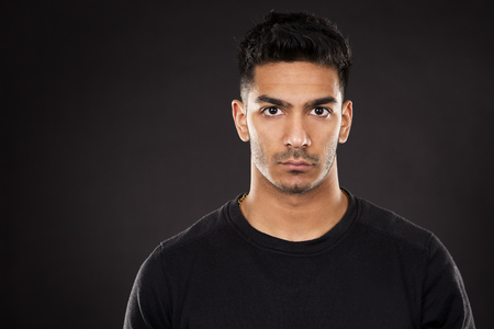 young fit indian man wearing dark workout outfitの写真素材