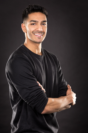 young fit indian man wearing dark workout outfitの写真素材