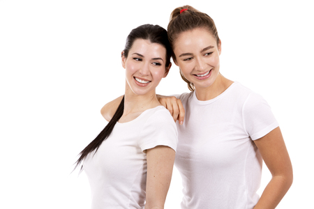 young casual caucasian women wearing white tshirt and blue jeans on white isolated backgroundの写真素材