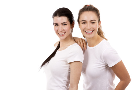 young casual caucasian women wearing white tshirt and blue jeans on white isolated backgroundの写真素材