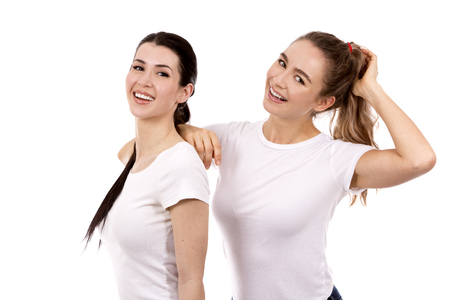 young casual caucasian women wearing white tshirt and blue jeans on white isolated backgroundの写真素材