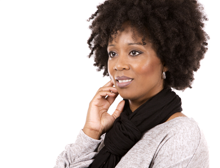 beautiful casual black woman wearing light top and black scarft on white isolated backgroundの写真素材