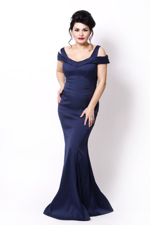elegant woman wearing evening gown in dark blue or navy color on white backgroundの写真素材