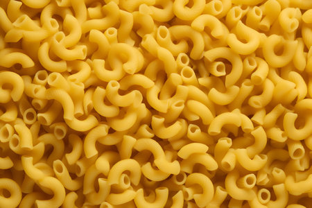 closeup of a pile of uncooked italian macaroni pastaの素材