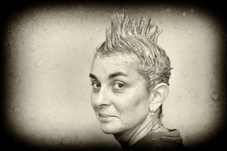 Portrait of a woman with shampooed spiky hairの写真素材