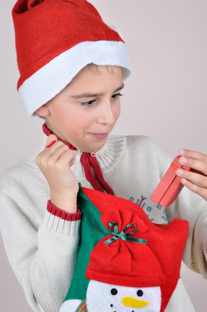 Cute young surprised boy looking at Christmas presentの写真素材