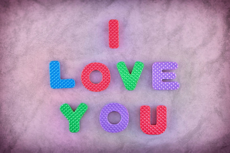 I love you sign made out of alphabet isolated on pink backgroundの写真素材