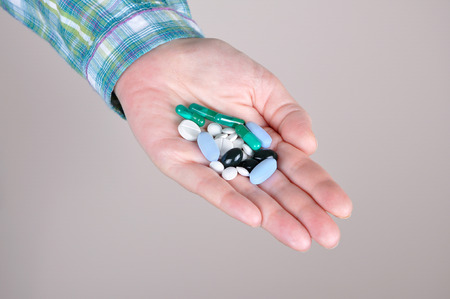 Woman holding a bunch of drugs in her handの写真素材