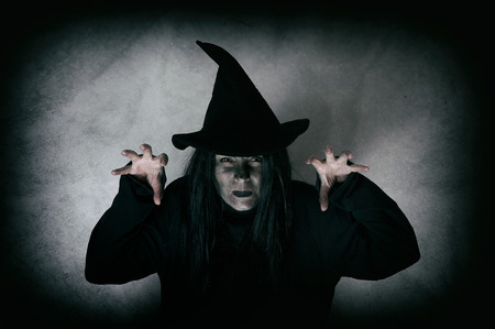 Halloween witch. Low key. Computer added dirt, scratches, grain and vignette.の写真素材