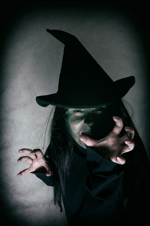 Halloween witch. Low key. Computer added dirt, scratches, grain and vignette.の写真素材