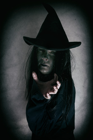 Halloween witch. Low key. Computer added dirt, scratches, grain and vignette.の写真素材
