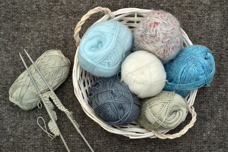Knitting accessories on the woolen background. Top view.