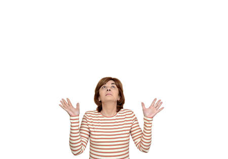 Smiling woman with open palms for copy space looking up. Isolated on the white background.の写真素材