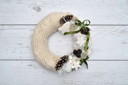 Decorated handmade Christmas wreath on the rustic wooden table. High angle view.の写真素材