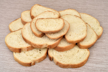 Stack of sliced fresh homemade white bread on the rustic wooden tableの写真素材