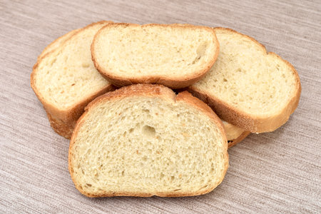 Stack of sliced fresh homemade white bread on the rustic wooden tableの写真素材
