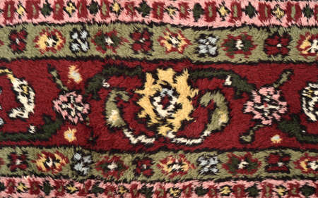 Detail of a very old Persian carpet after cleaning, washing and repairing. Close-up. Top view.の写真素材