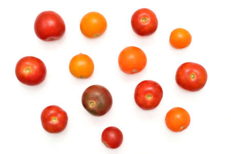 Different variety, color and size fresh organic cherry tomatoes picked up in the garden isolated on the white background. Top view.の写真素材