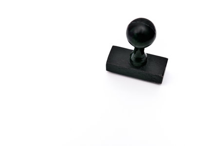 Black wooden rubber stamp with the copy space on the white paperの写真素材