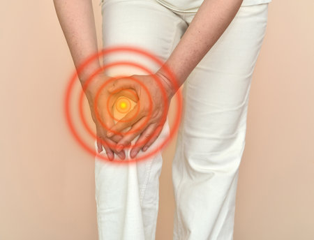 Woman with knee pain holding her knee. Healthcare and medicine concept.の写真素材