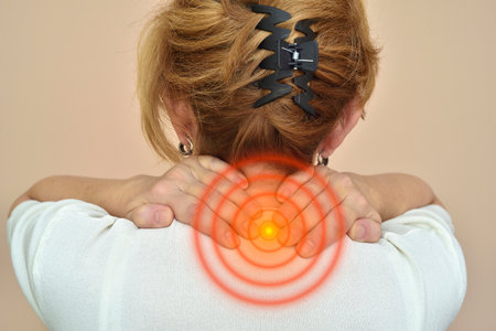 Woman with neck pain holding her neck. Healthcare and medicine concept.の写真素材