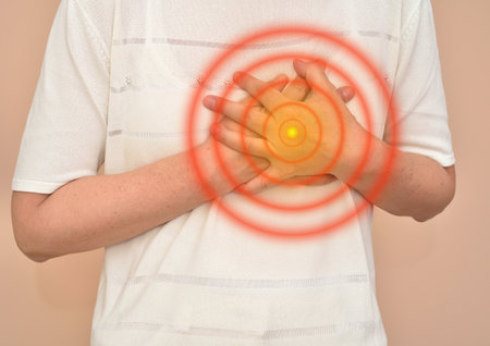 Woman with heart attack holding her chest. Healthcare and medicine concept.の写真素材