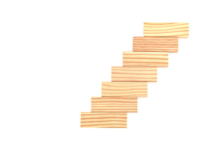 Wooden blocks stacked in the shape of stairs isolated on the white background. Copy space. Top view. Success in business growth concept.の写真素材