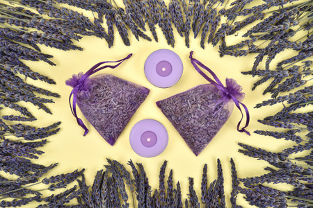 Lavender flowers and lavender products on the yellow background. Top view.の写真素材
