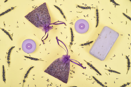 Lavender flowers and lavender products on the yellow background. Top view.の写真素材